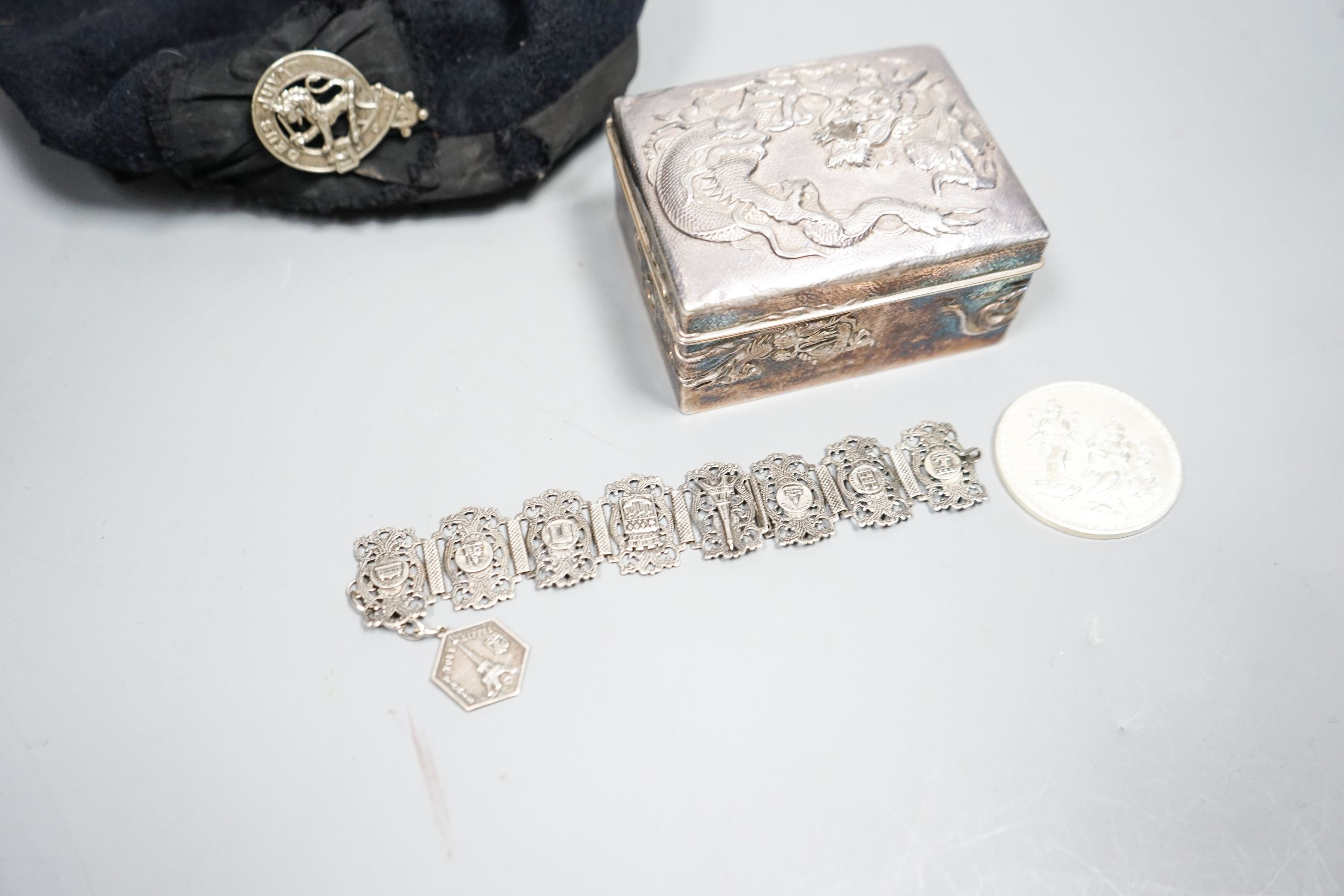 A Japanese silver box, bracelet, medal and military cap